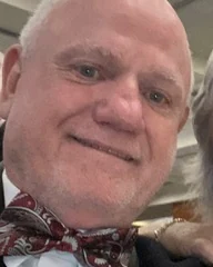 Kelvin Brown, smiling, in a paisley bow tie